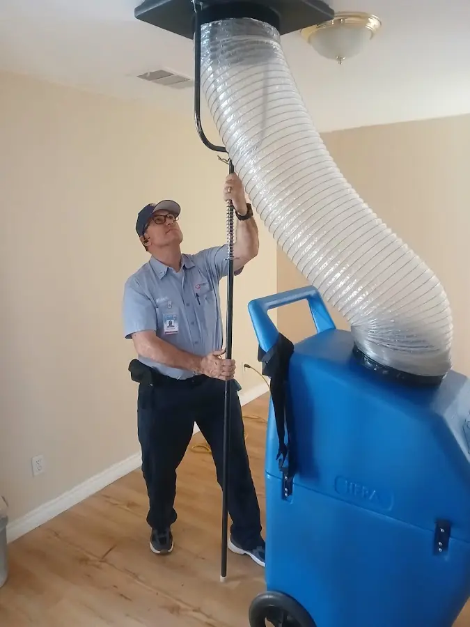 Furnace Tune-Up technician using HEPA equipment in California